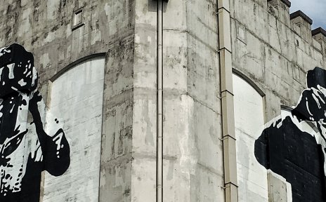 Streetart auf einem Bunker zeigt zwei menschliche Figuren mit Fernglas Streetart auf einem Bunker zeigt zwei menschliche Figuren mit Fernglas