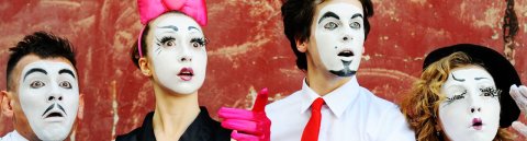 Zwei Schauspieler und zwei Schauspielerinnen mit schwarz-weiß geschminkten Gesichtern. Zwei Schauspieler und zwei Schauspielerinnen mit schwarz-weiß geschminkten Gesichtern.